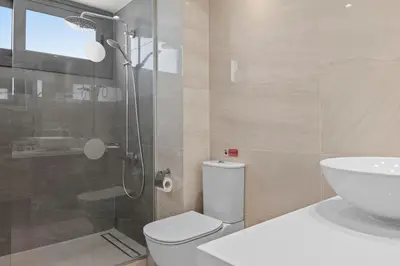 a bathroom with a shower and a toilet and a sink at Serenity Waves Villa 9 in Sophtadhes