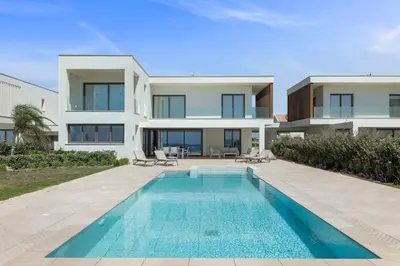 an exterior view of a house with a swimming pool at Serenity Waves Villa 4 in Sophtadhes