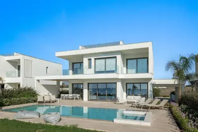 a large white house with a swimming pool at Serenity Waves Villa 3 in Sophtadhes