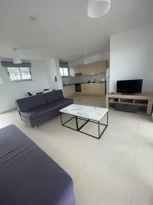 a living room with a couch and a coffee table at Fig Tree View Apartments in Protaras