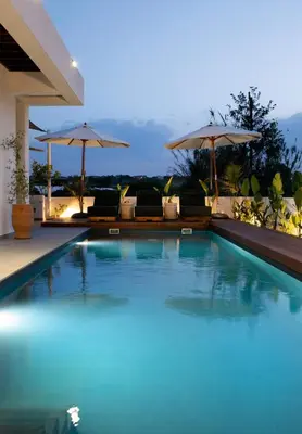 a swimming pool with chairs and umbrellas at Amazing Protaras Villa Villa Lubbock 3 Bedrooms Private Outdoor Pool in Protaras