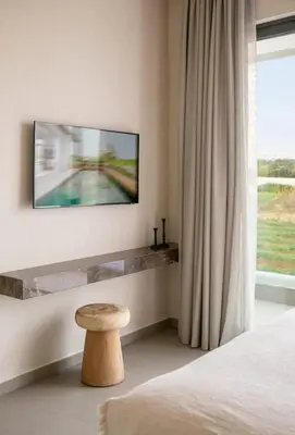 a bedroom with a bed and a table and a window at Amazing Protaras Villa Villa Lubbock 3 Bedrooms Private Outdoor Pool in Protaras