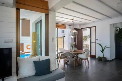 a living room with a couch and a table with chairs at Extraordinary Protaras Villa Villa Leone 3 Bedrooms Private Outdoor Pool in Protaras
