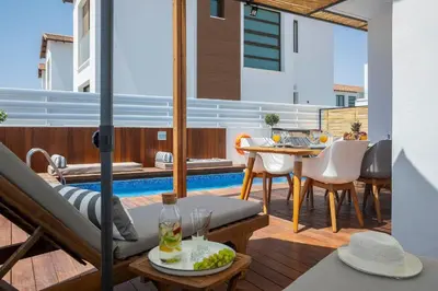 a patio with a table and chairs and a pool at Extraordinary Protaras Villa Villa Leone 3 Bedrooms Private Outdoor Pool in Protaras