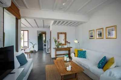 a living room with a white couch and a table at Extraordinary Protaras Villa Villa Leone 3 Bedrooms Private Outdoor Pool in Protaras