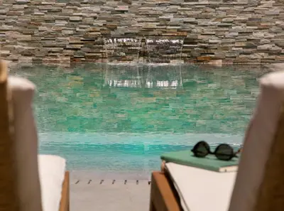 a pair of glasses sitting on a table next to a pool at Magnificent Protaras Villa Villa Chelsea 3 Bedrooms Private Outdoor Pool in Protaras