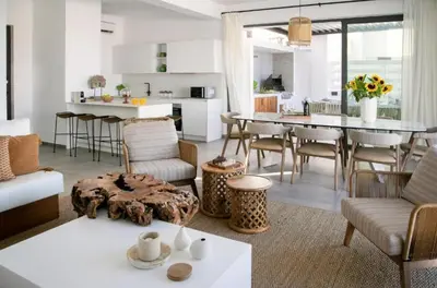 a living room and kitchen with a table and chairs at Magnificent Protaras Villa Villa Chelsea 3 Bedrooms Private Outdoor Pool in Protaras