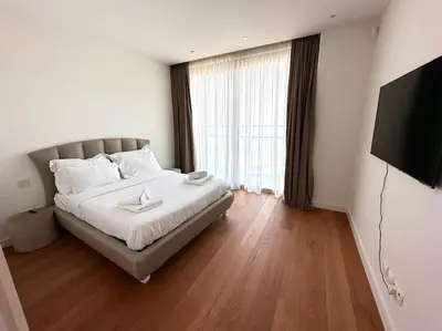 a bedroom with a bed and a flat screen tv at Del Mar Beachfront 3 Bedroom 'A' Residence in Limassol