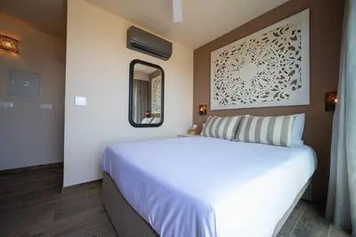 a bedroom with a white bed and a mirror at Exotic Sea Boutique Adults Only in Protaras
