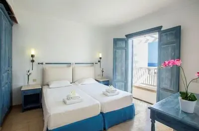 a bedroom with a large bed and a balcony at Premium Protaras Villa Villa Mine 2 Bedrooms Private Outdoor Pool in Protaras
