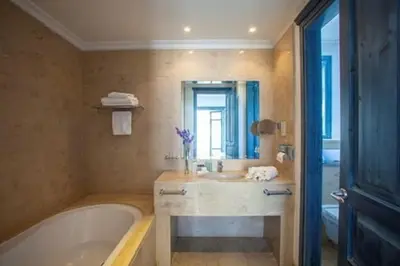 a bathroom with a bath tub and a sink at Premium Protaras Villa Villa Mine 2 Bedrooms Private Outdoor Pool in Protaras