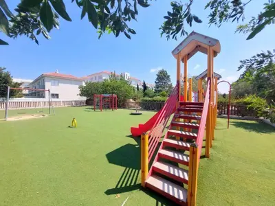 a playground with a slide in a park at Mythical Sands - Escape in Paralimni