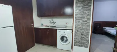 a kitchen with a washing machine and a sink at Paradise by the Sea in Larnaka