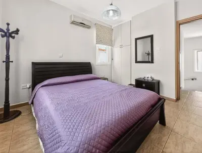 a bedroom with a bed with a purple comforter at Villa Ioli - 3BR Retreat near Kalamies Beach in Protaras
