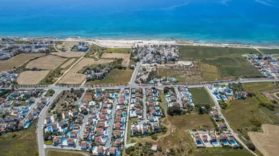 an aerial view of a parking lot next to the ocean at Elena Gardens Villa in Ayia Napa