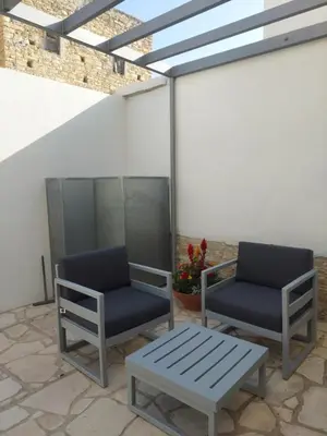 two chairs and a bench on a patio at AROMA DRYOS in Kato Drys