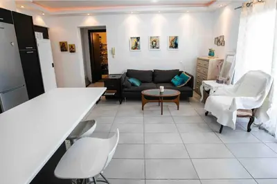 a living room with a couch and a table at Central cozy apt in quiet area in Engomi in Nicosia