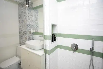 a bathroom with a sink and a toilet at Palmove Luxurious Beachfront Apt in Larnaka