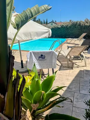 a patio with a table and chairs and a pool at Potamos Villa - Villa Kymma 4 in Ayia Napa