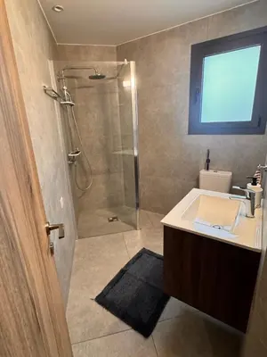 a bathroom with a shower and a sink at Maroulla's Urban Beach Living in Limassol