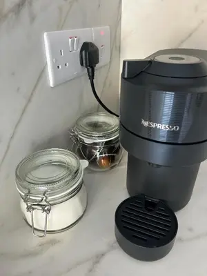 a coffee maker sitting on a counter next to jars at Maroulla's Urban Beach Living in Limassol
