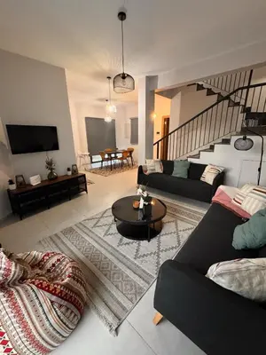 a living room with two couches and a table at Maroulla's Urban Beach Living in Limassol