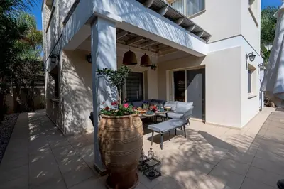 a patio with a barrel and a table and chairs at Stylish & Picturesque Oasis Anthorina 2 in Protaras