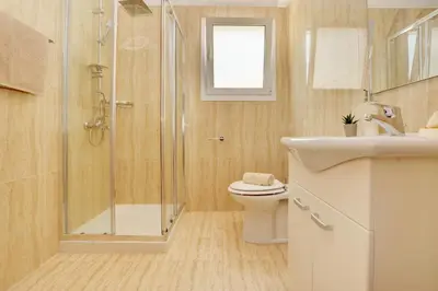 a bathroom with a shower and a toilet and a sink at La Bella Nissi Villa in Ayia Napa