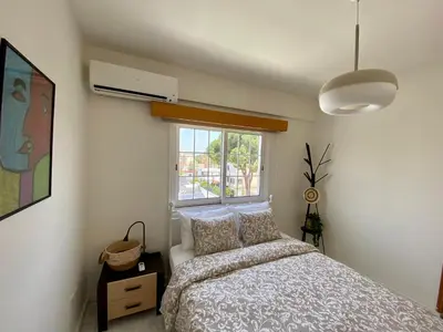 a bedroom with a bed and a window at Sunny 2 bedroom flat in Engomi in Engomi