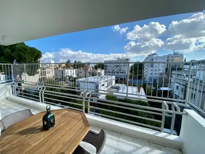 a balcony with a table and a view of a city at Sunny 2 bedroom flat in Engomi in Engomi