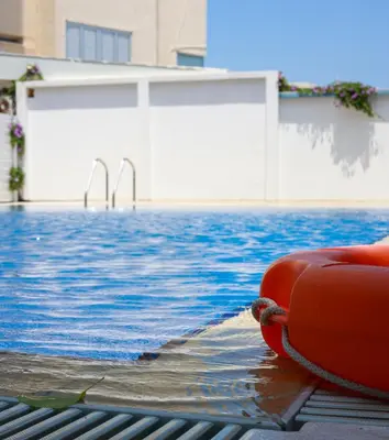 a redotation device sitting next to a swimming pool at Piale Palms Makenzie Beach Front Apartment, Larnaca in Larnaka