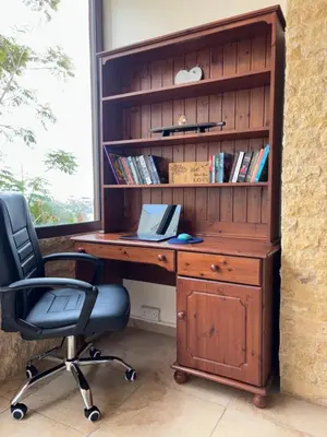 a wooden desk with a chair and a book shelf at Piale Palms Makenzie Beach Front Apartment, Larnaca in Larnaka