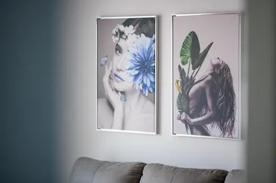 two pictures on a wall above a couch at Olympia Flat 104 in Larnaka