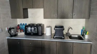 a kitchen counter with a microwave and a sink at SPECIAL OFFER -70 Percent Off - 2 BR - Sleep 7 - Best Location at Ayia Napa City Center in Ayia Napa