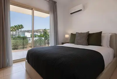 a bedroom with a large bed and a large window at Phaedrus Living Limassol Pyrgos Seaside Flat in Limassol
