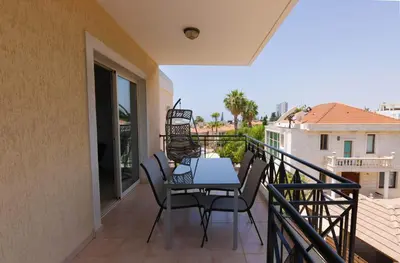 a patio with a table and chairs on a balcony at Phaedrus Living Limassol Pyrgos Seaside Flat in Limassol