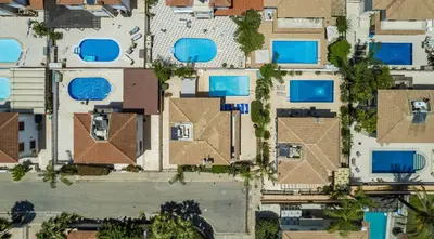 an overhead view of houses with blue roofs at Villa Lindo in Protaras