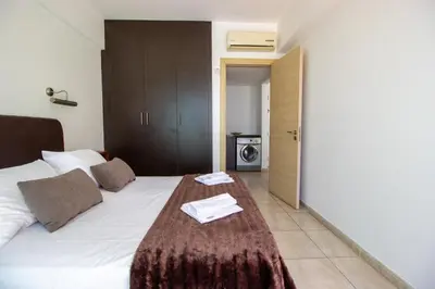 a hotel room with a bed with a table on it at Prime Protaras Seafront Apt in Protaras