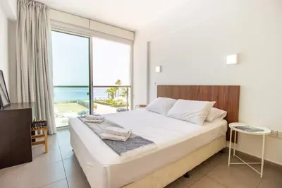a bedroom with a large bed and a large window at Stunning Sea-Views Apt, Protaras in Protaras