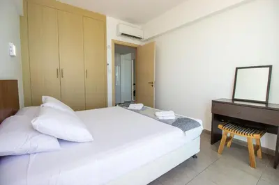 a bedroom with a white bed and a piano at Stunning Sea-Views Apt, Protaras in Protaras