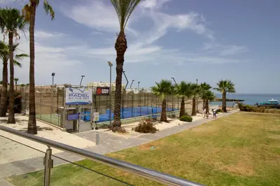 a park with palm trees and a swimming pool at Stunning Sea-Views Apt, Protaras in Protaras