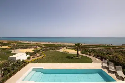 a swimming pool with a view of the ocean at Serenity Waves Villa 6 in Sophtadhes