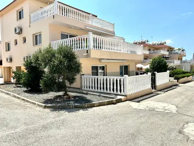 a building with a white fence in front of it at Nissi Golden Sands Apartment D01 in Ayia Napa
