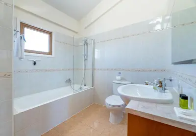 a bathroom with a sink and a toilet and a shower at Villa Stephanie Oasis in Ayia Napa