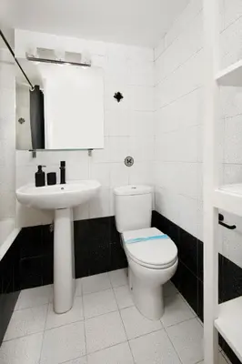 a white bathroom with a toilet and a sink at Urban Condo 11 - 1 Bdr in Nicosia