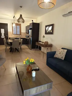 a living room with a couch and a table at Mythical Sands - Aura in Paralimni