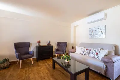 a living room with a couch and two chairs at Traditional House Agia Varvara Village in Ayvaryara