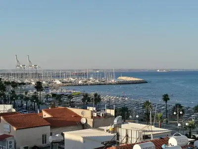 a view of a harbor with buildings and the ocean at Must Stay - Finikoudes Studio in Larnaka