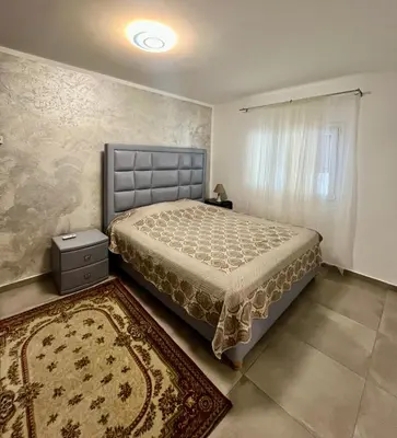 a bedroom with a bed and a rug at A Detached Floor in Parekklisha