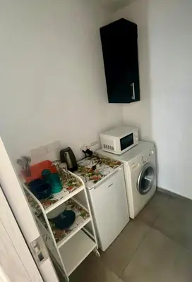a laundry room with a washing machine and a microwave at A Detached Floor in Parekklisha
